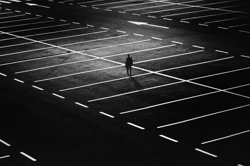 Photograph of a man in dark parking lot digitally manipulated